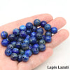 A handful of deep blue lapis lazuli round beads for jewelry making