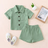 A baby boy outfit set featuring a mint green cotton linen shirt and matching shorts.