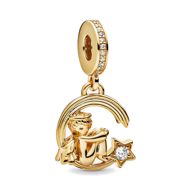 Gold charm bracelet featuring pendants of an elephant, key, butterfly, and heart.