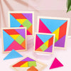 A wooden tangram puzzle set showing various colored triangular pieces arranged in different patterns on a white surface.