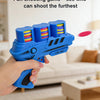 A hand holds a blue foam toy gun with colorful discs, ready to be played indoors.