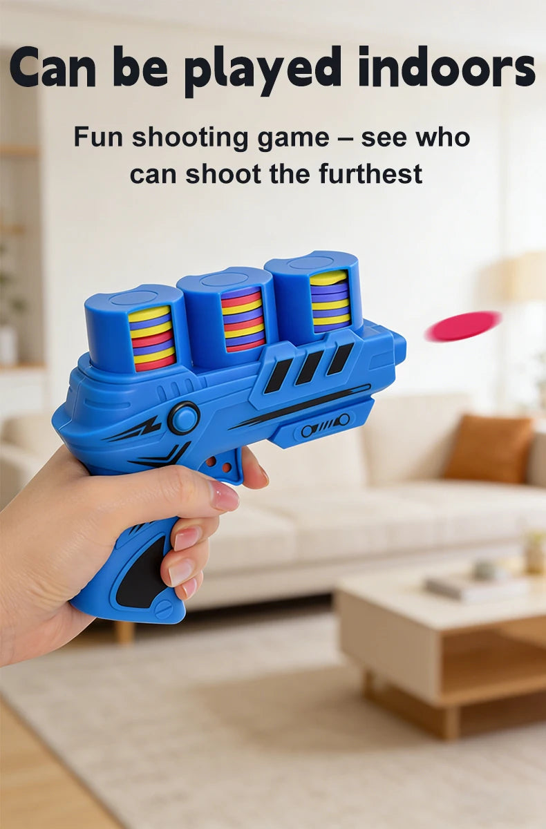 A hand holds a blue foam toy gun with colorful discs, ready to be played indoors.