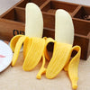 Yellow stretchy banana fidget toy resting on a wooden box.