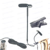 A black clip-on condenser microphone with a gooseneck stand and cable, next to a clip mount and a gold-colored instrument.