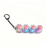 A set of silicone paw print keyboard keychains with LED lights attached to a metal keyring.