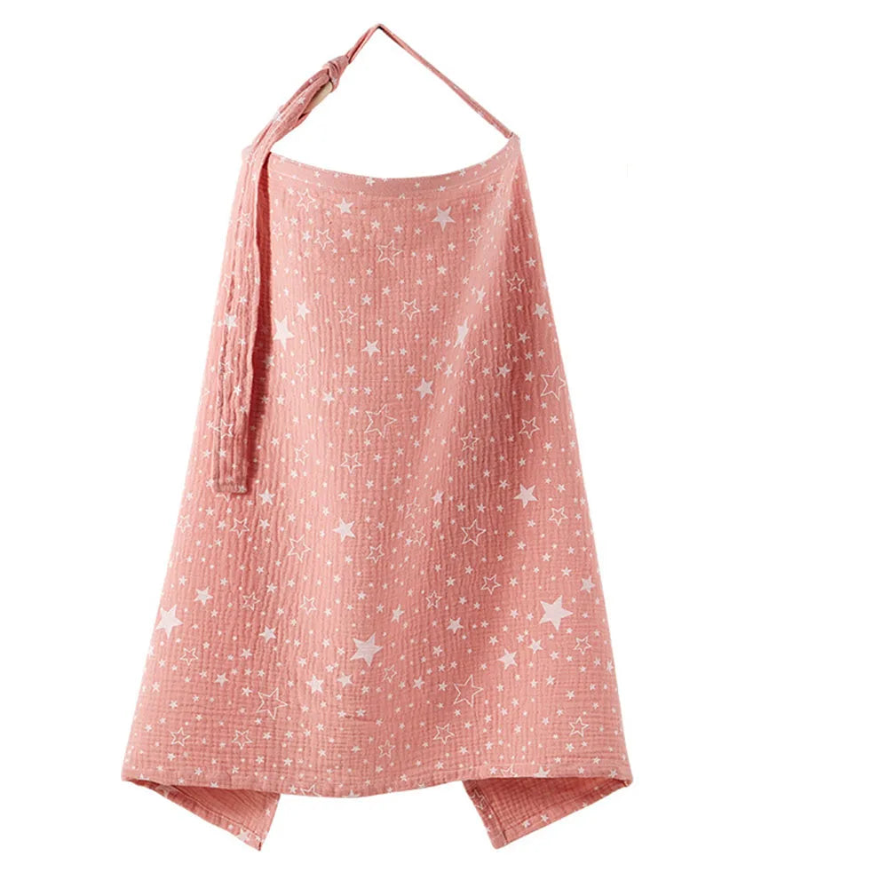A pink breathable muslin nursing cover with a star print