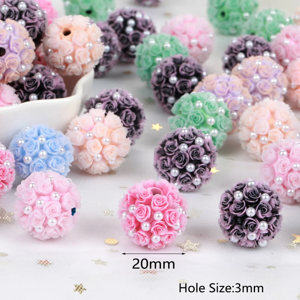 Assortment of pink, purple, and green rose flower ball acrylic beads for jewelry making with a size reference.