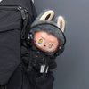Labubu doll wearing a black bear hoodie and headphones