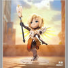A blonde female Overwatch Play of the Game collectible PVC figurine with golden wings and a staff, standing on a clear base.