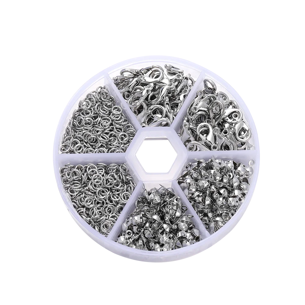 A circular plastic tray divided into six sections holding various jewelry making components like clasps, jump rings, and crim