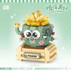 A green building block set shaped like a cute monster holding a golden floral bouquet.