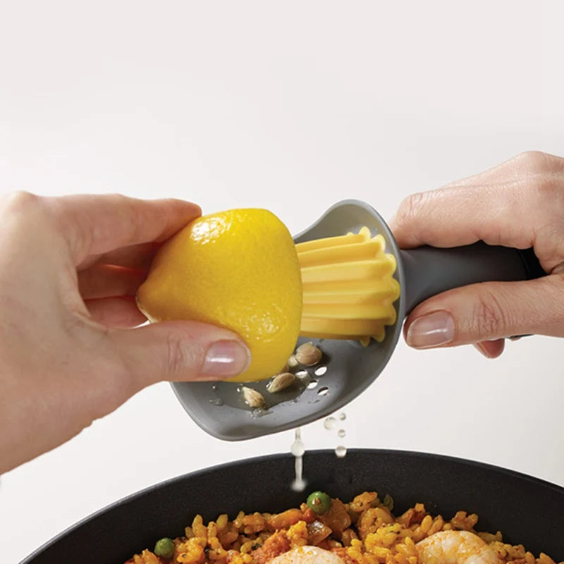 A hand is using a manual citrus juicer to extract juice from a yellow lemon.