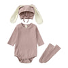 A mauve rabbit romper set for babies includes a matching hat and socks.