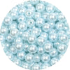 A close-up view of small, light blue imitation pearl beads scattered in a pile.