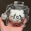 A white Hachiware Usagi squishy stress relief toy is shown inside clear packaging with a decorative tag.