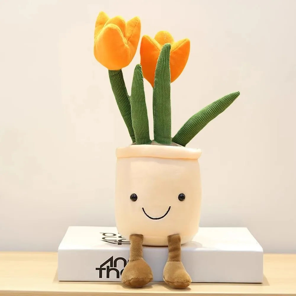 A cute plush toy of a tulip succulent plant with green leaves and orange flowers growing out of a white pot.