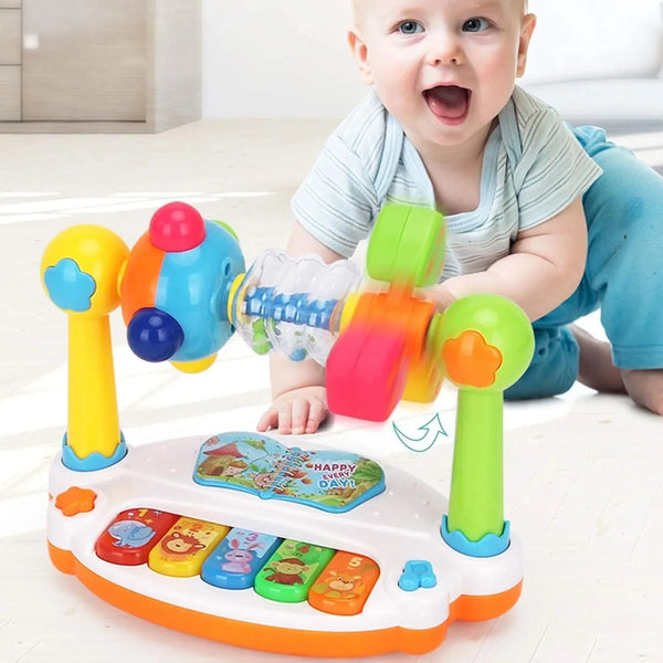 A baby is interacting with a colorful musical rotating piano toy designed for toddlers.