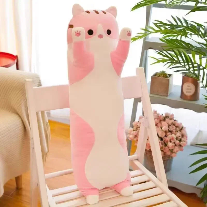 A pink and white plush cat pillow is displayed on a white wooden chair.