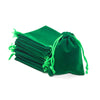 A dark green compact drawstring bag filled with stacked dice for tabletop games