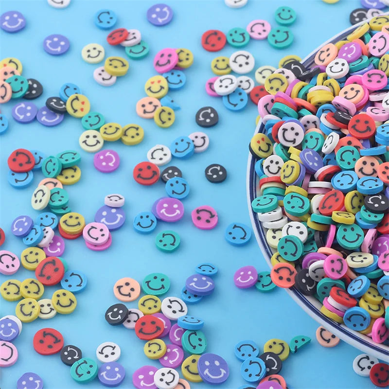 A close-up of mixed color polymer clay sprinkles scattered on a light blue surface.
