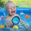 A baby is playing in a pool with various floating toys including a shark, an orange ball, and a blue fishing net toy.