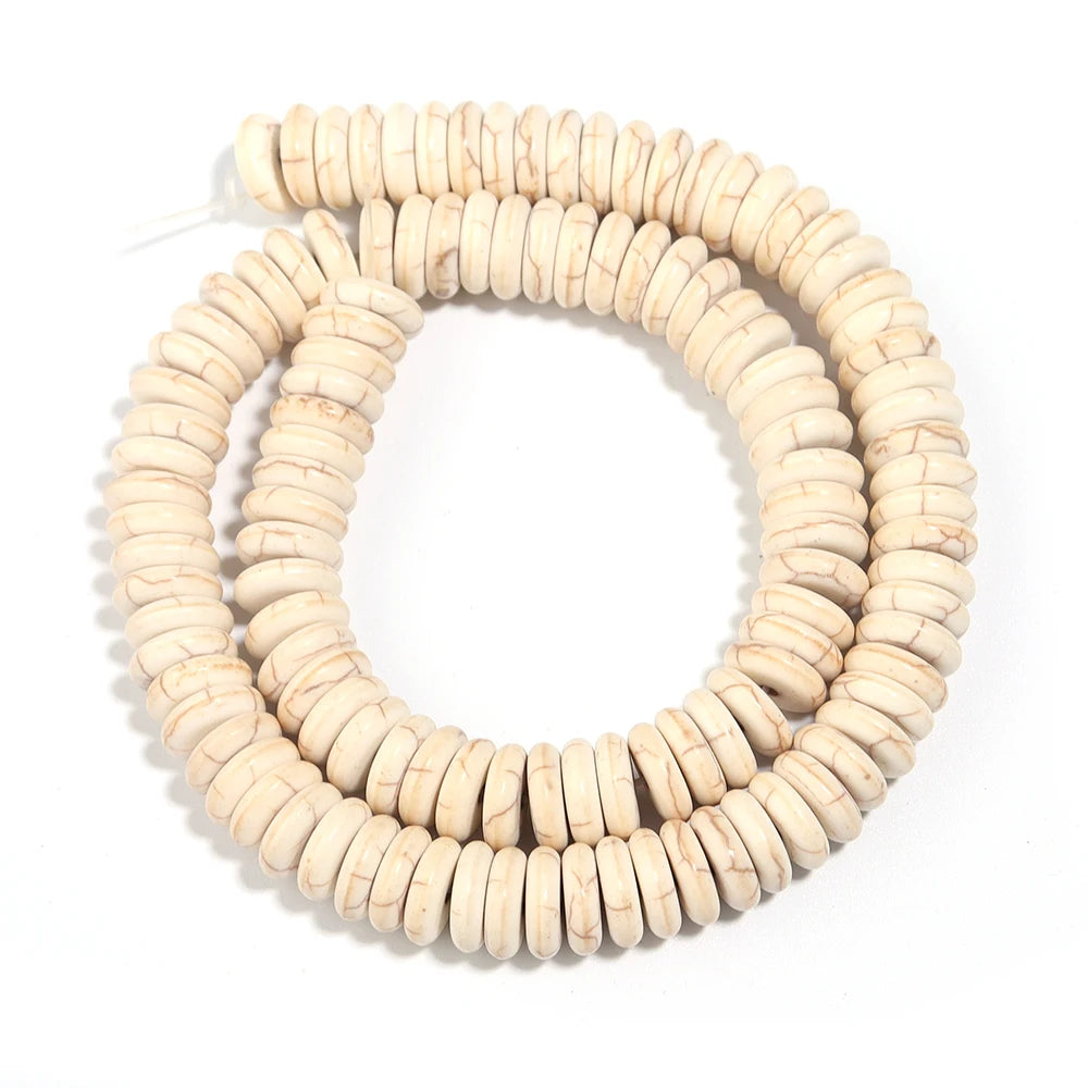 A strand of natural light beige turquoise stone beads coiled into a circular shape for jewelry making