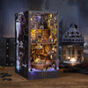 A detailed wooden pirate ship book nook kit featuring a miniature scene with rigging and figures.