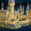 A detailed LEGO-style model of a medieval castle built from tan and gray bricks on a water base.