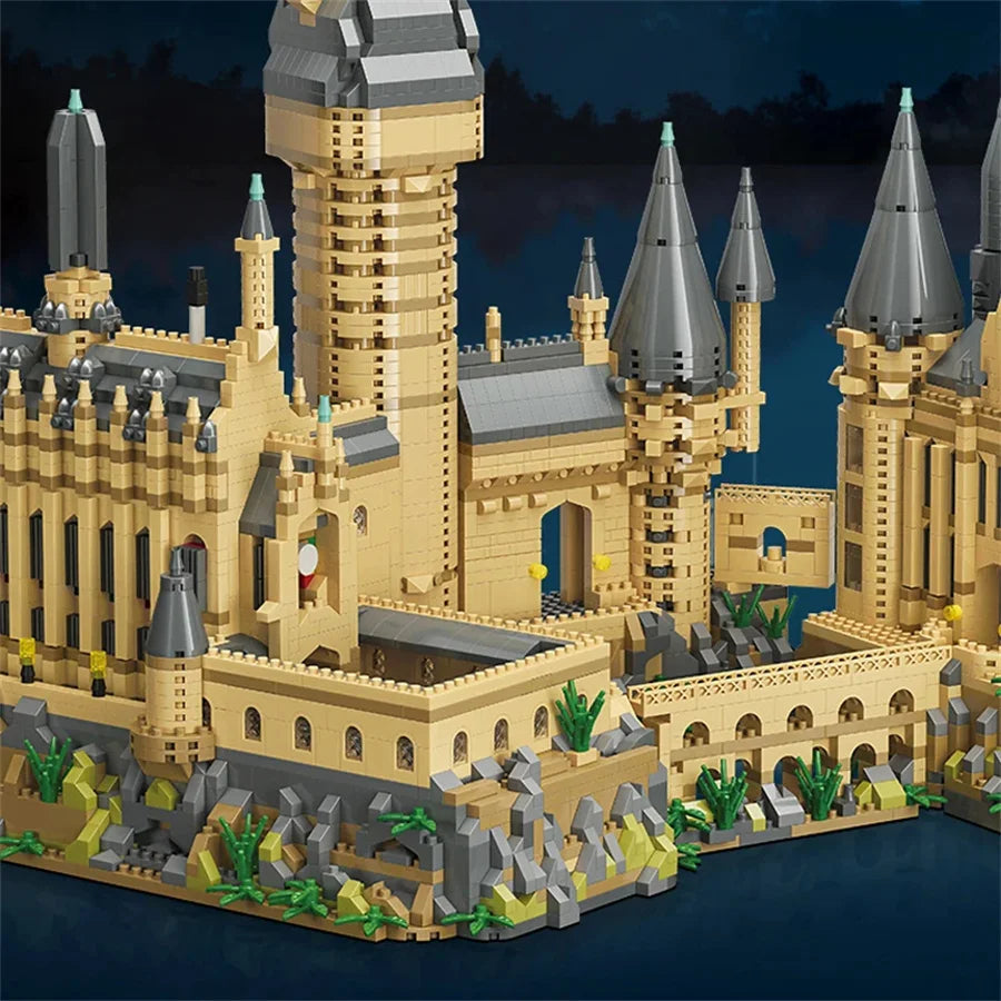 A detailed LEGO-style model of a medieval castle built from tan and gray bricks on a water base.
