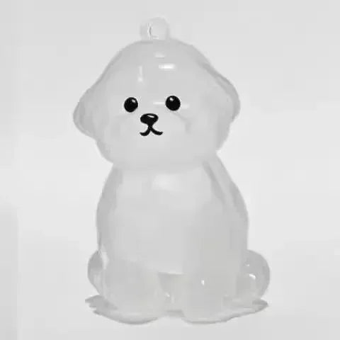 A clear, dog-shaped pet hair keepsake keychain with a smooth, rounded design.