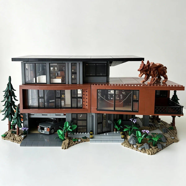 Maquette détaillée d'un manoir de vampires hanté construit en briques marron foncé et grises, avec une structure à plusieurs