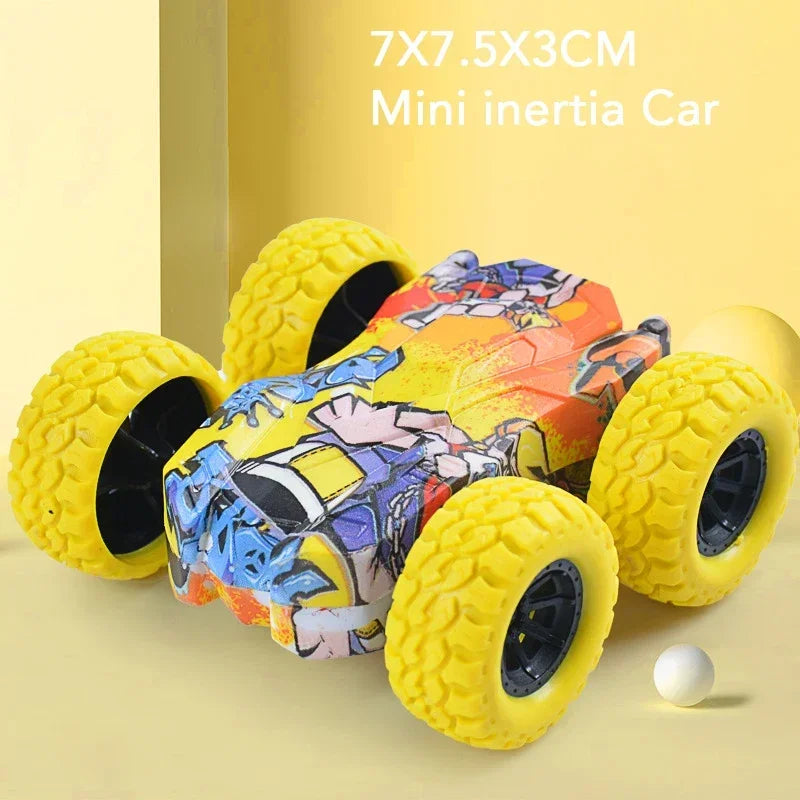 A yellow mini inertia car toy with a colorful, patterned body and black wheels is displayed on a light surface.