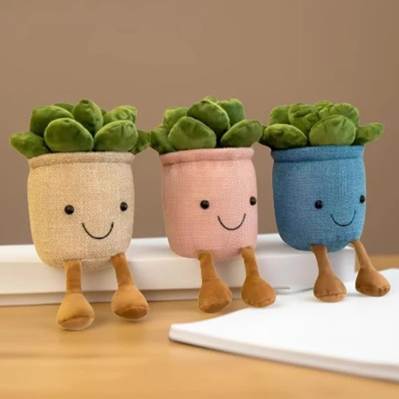 Three plush succulent stuffed toys in pastel pots with smiling faces