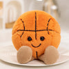An orange plush doll shaped like a basketball with stitched details, sitting on a white plate.