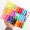 A clear plastic bag containing an air-dry modeling clay set with various colored clay pieces and tools.