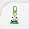 A green padlock keychain featuring a cute panda charm and a small flower, displayed on a white background.