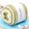 A skein of light green and yellow gradient yarn labeled Fairyland Long distance cake ball