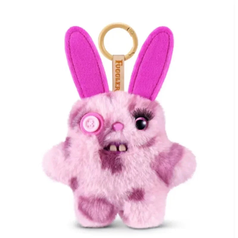 A pink fluffy alien plush toy with large ears and a gold keychain ring.