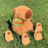 A brown capybara plush family set featuring a mama bear and four baby bears lying on green grass.