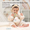 A baby is holding a silicone teether set for babies with a white plush toy and colorful silicone rings.