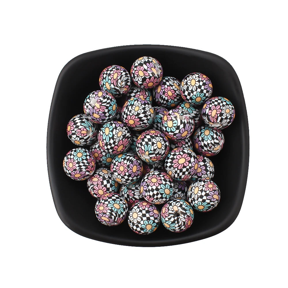 A black dish filled with small, round silicone beads featuring a leopard and daisy print.