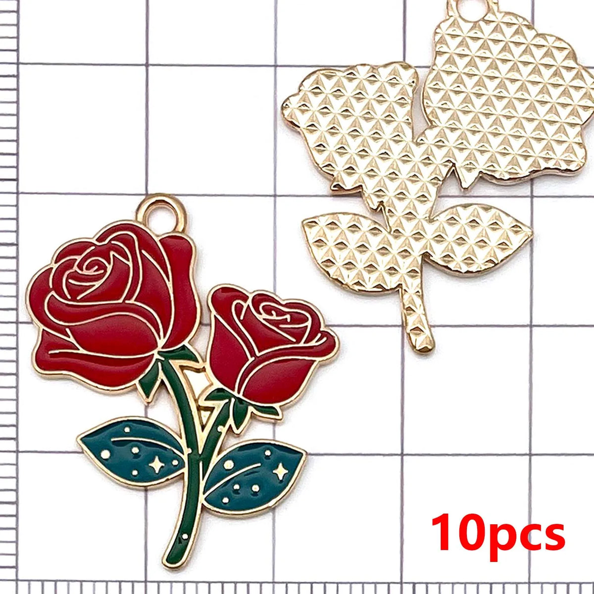 A set of ten gold-toned enamel flower charms, including a red rose and a green leaf, displayed on a grid background.
