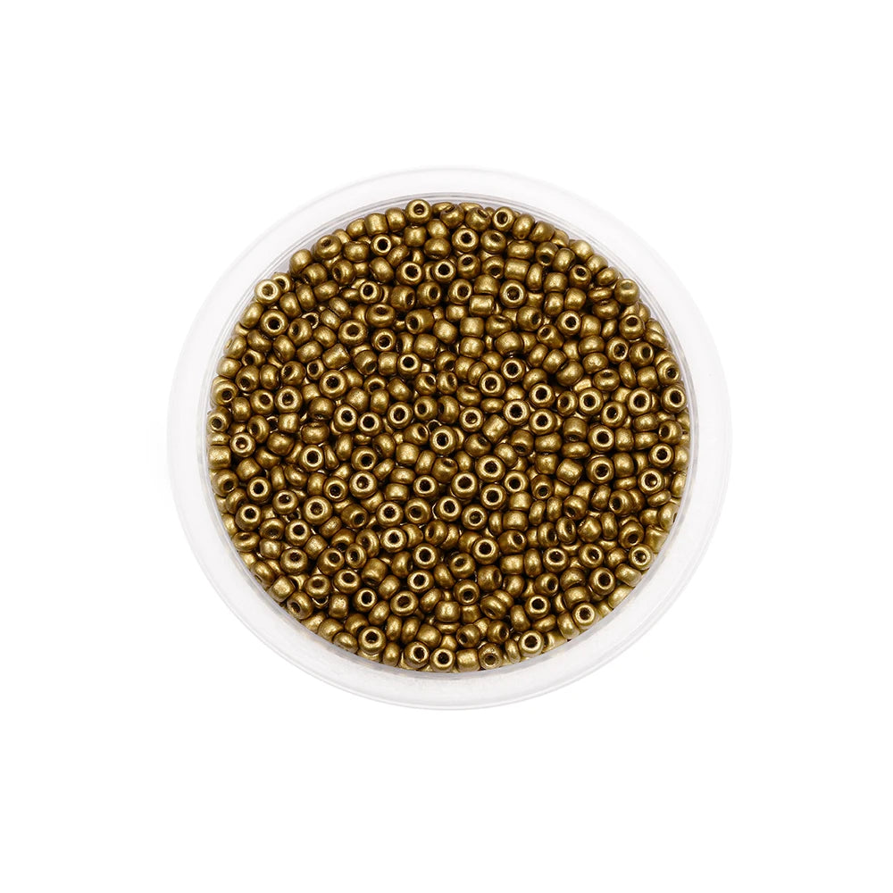 A clear container filled with small round brass or gold-colored glass seed beads for jewelry making.
