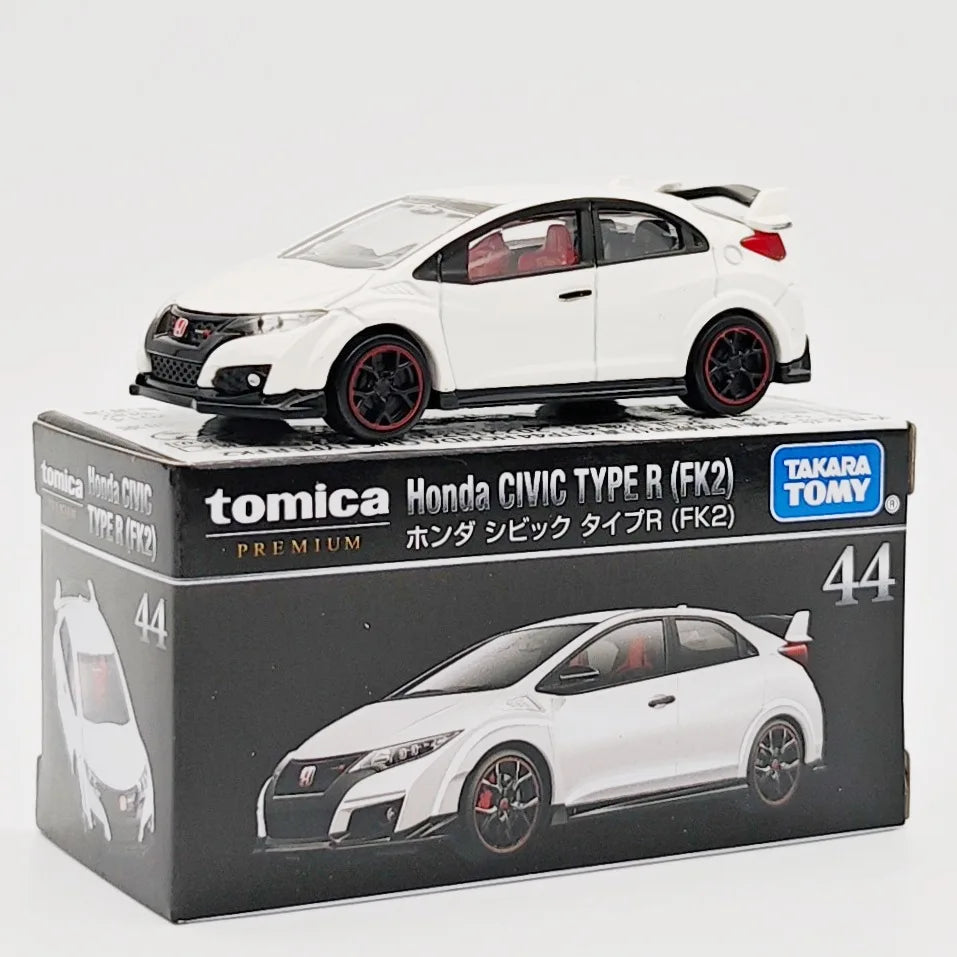 A white Honda Civic Type R model car in a box, featuring a red spoiler and black wheels.
