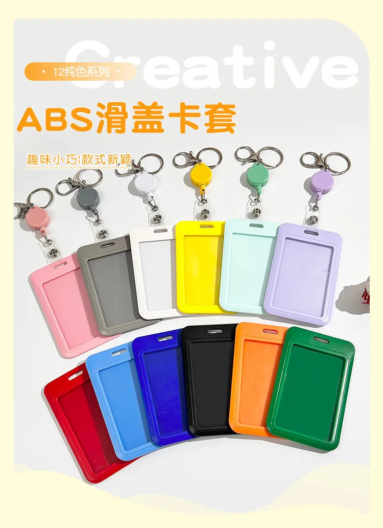 A collection of colorful ABS plastic ID badge holders with metal keychains and clips displayed in various shades.