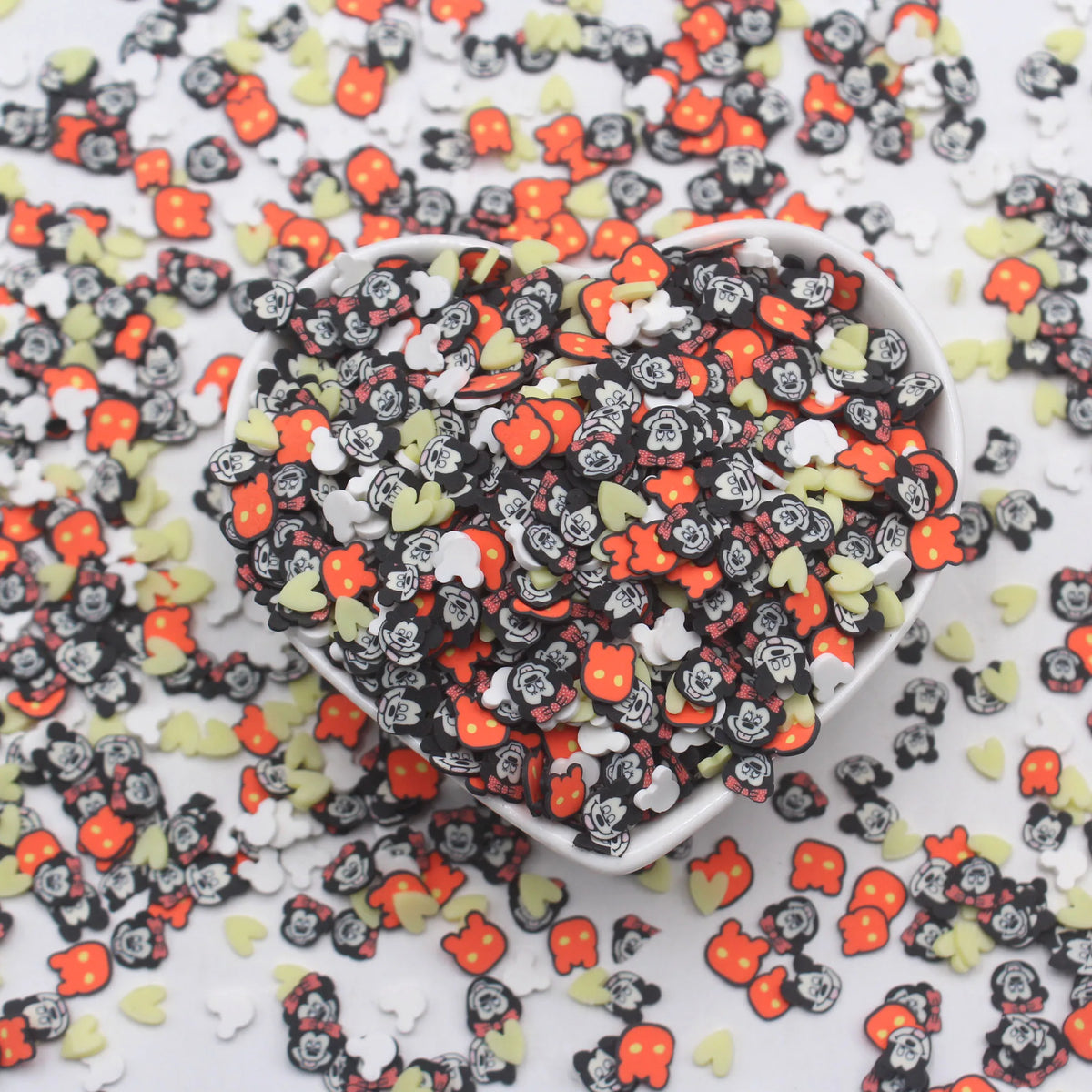 A pile of colorful cartoon polymer clay slices in various shapes and colors for slime and craft projects