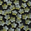 A collection of small, translucent light green glass flower beads for jewelry making