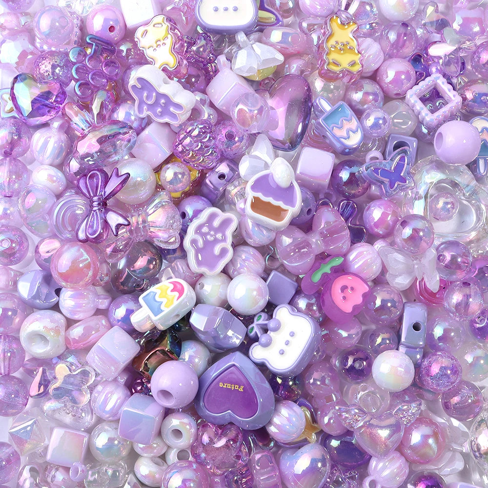 A close-up of small, colorful acrylic bow beads in various shades of purple and pink.