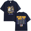 A dark blue t-shirt featuring a graphic of a musician performing on stage with the text HIT ME HARD AND SOFT THE TOUR
