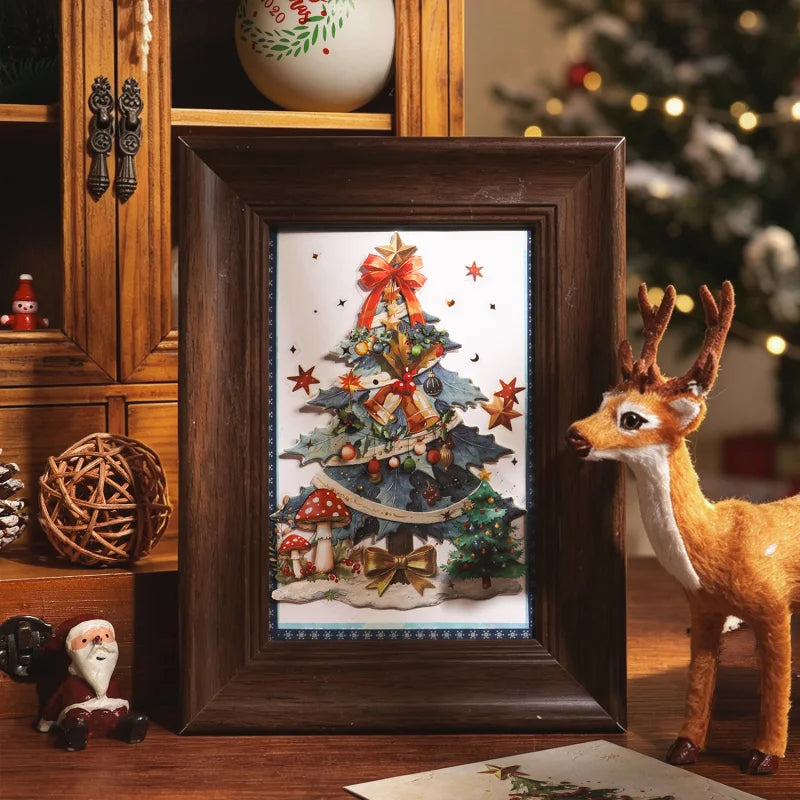 A framed illustration of a Christmas tree decorated with stars and gifts, set in a dark wooden frame.